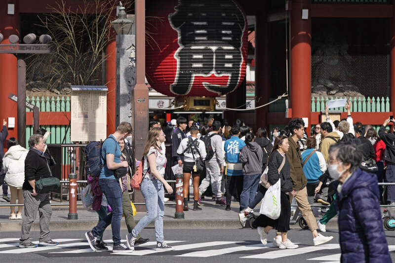 圖為15日東京觀光景點前遊客隨著氣溫上升換上輕薄短袖。（共同社）