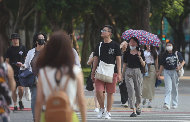 圖為台北市信義區街頭民眾撐傘遮陽。（中央社檔案照片）