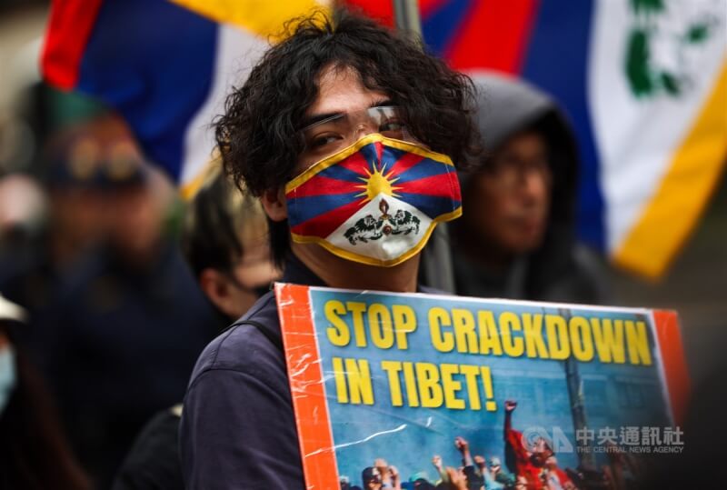 「西藏的未來 世界的未來」西藏抗暴65週年大遊行10日下午在台北登場，一名參與者手拿標語海報，呼籲中共政權停止在西藏的鎮壓迫害。中央社記者裴禛攝 113年3月10日