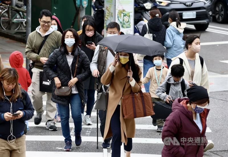 圖為台北市士林區民眾穿外套禦寒。（中央社檔案照片）