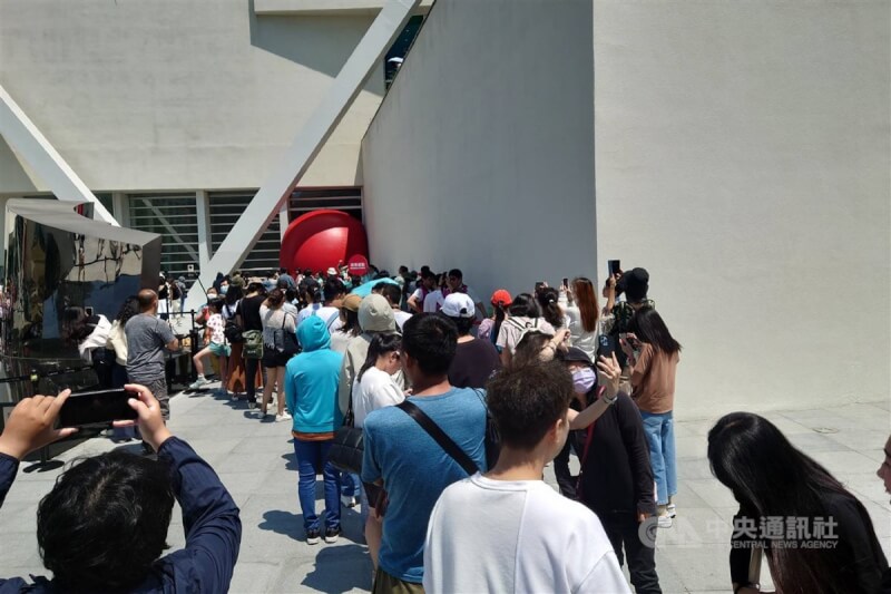 大批民众前往排队等待近距离欣赏红球、拍照互动。中央社记者杨思瑞摄 113年4月3日
