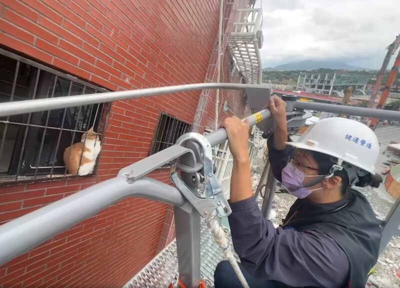 消防局調派雲梯車救援卡在天王星大樓鐵窗的橘貓。（圖取自facebook.com/HLCFD119）