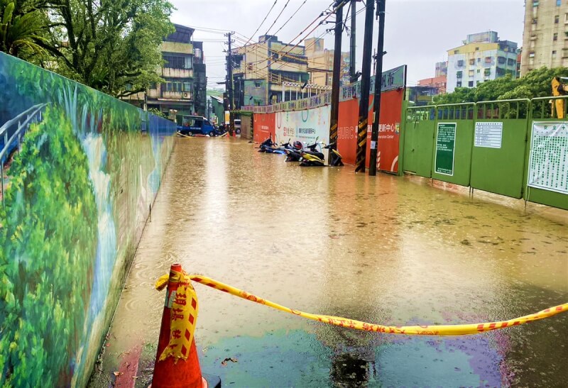 新北市18日上午下起大雨,汐止區中華街靠原茄苳停車場出入口一側積水,汐止警分局於現場設置封鎖線,管制人車通行並進行交通疏導。(汐止警分局提供)中央社記者黃旭昇新北傳真 113年4月18日