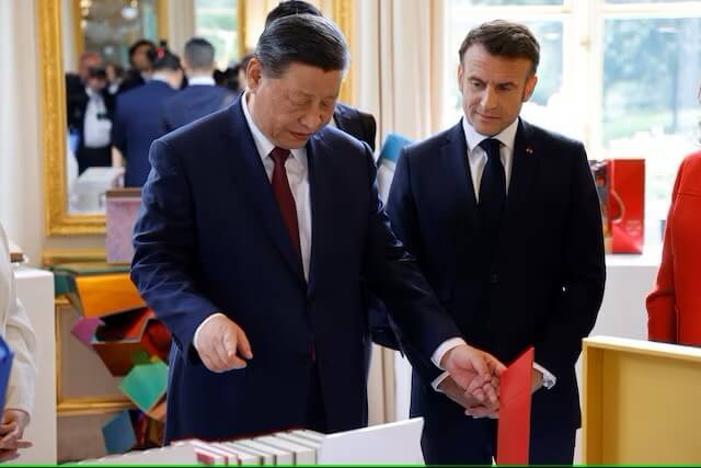 中國國家主席習近平（左）6日將法籍作家在中國出版品致贈法國總統馬克宏（右）。（LUDOVIC MARIN/Pool via 路透社）
