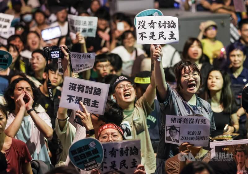 24日晚上立院周邊集結大批人潮，青島東路上民眾手持寫有「沒有討論 不是民主」的標語表達立場。中央社記者鄭清元攝 113年5月24日