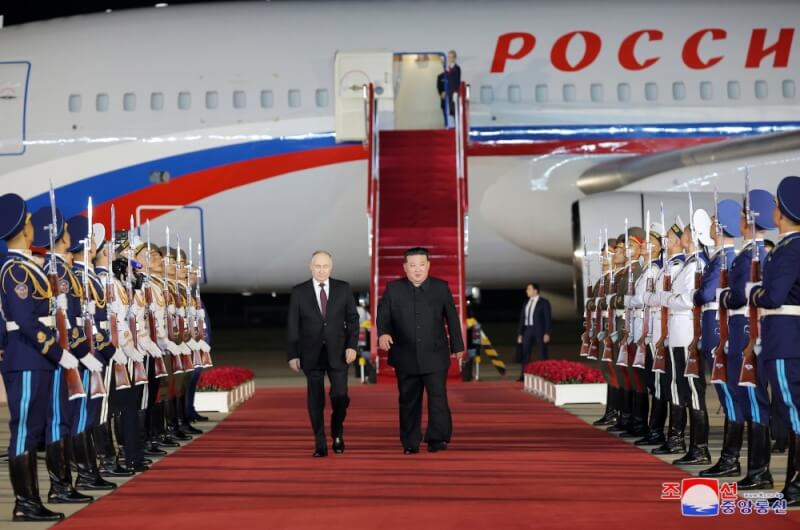 俄羅斯總統蒲亭（左）19日抵達平壤訪問，北韓領導人金正恩（右）在紅毯上熱情迎接。（圖取自北韓中央通信社網頁kcna.kp）