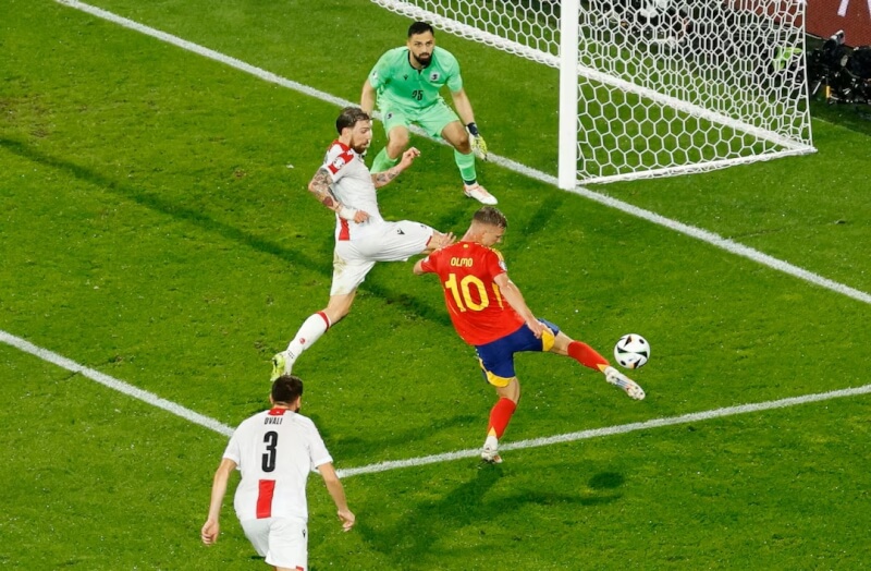 西班牙足球員奧爾莫（紅衣者）30日在歐洲國家盃對陣喬治亞時射門得分。（路透社）