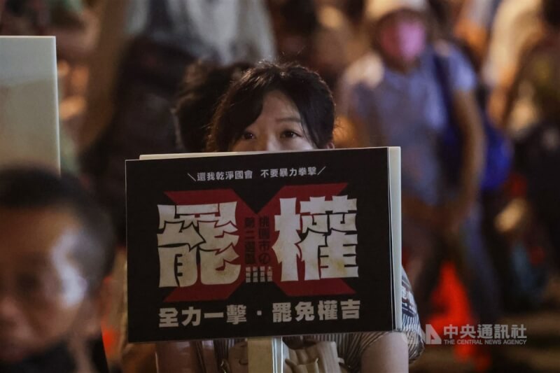 立法院內政委員會4日將排審選罷法修法,台灣公民陣線等民間團體3日晚間在立院外舉行「反對沒收罷免權 公民開講」晚會,民眾舉著標語,表達對於提高罷免門檻的抗議。中央社記者裴禛攝 113年7月3日