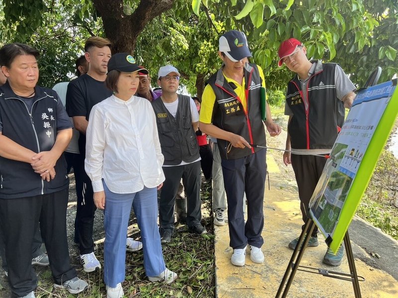 屏東縣長周春米（前左2）28日盤點颱風災損，於竹田鄉過溝橋聽簡報。屏東縣府計畫過溝橋改建，橋墩改為順水流方向減少衝擊、拓寬橋身，並加強興建兩岸護岸。（傳播暨國際事務處提供）中央社記者黃郁菁傳真  113年7月28日