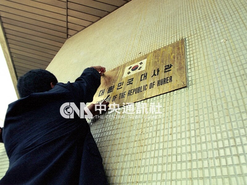 韓國駐華大使館人員用老虎鉗拆下韓國大使館館牌，準備撤館。中央社記者陳志嵐攝　81年8月24日