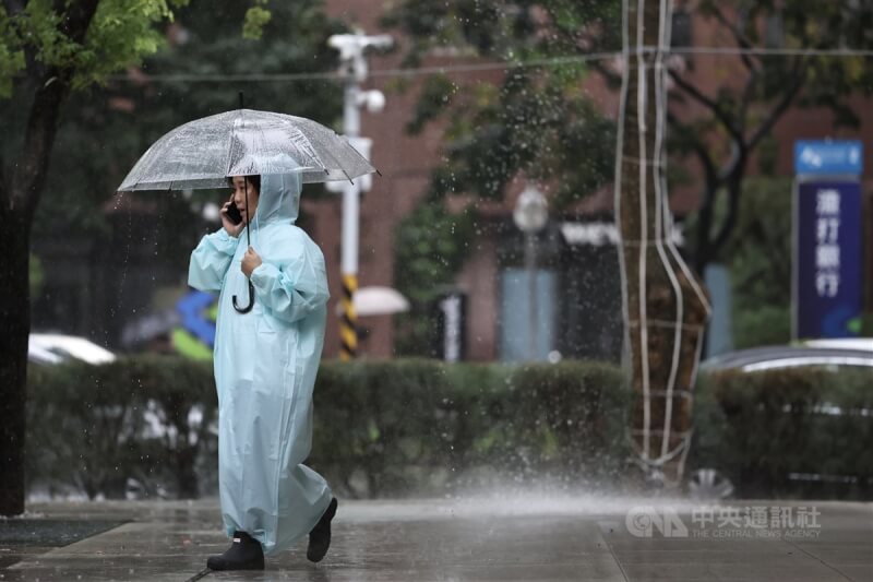 中央氣象署22日發布豪雨特報，受熱帶性低氣壓及低壓帶影響，環境不穩定，易有短延時強降雨，多個縣市注意局部大雨或豪雨。圖為台北市信義區民眾穿著雨衣並撐傘以防淋濕。中央社記者翁睿坤攝 113年9月22日