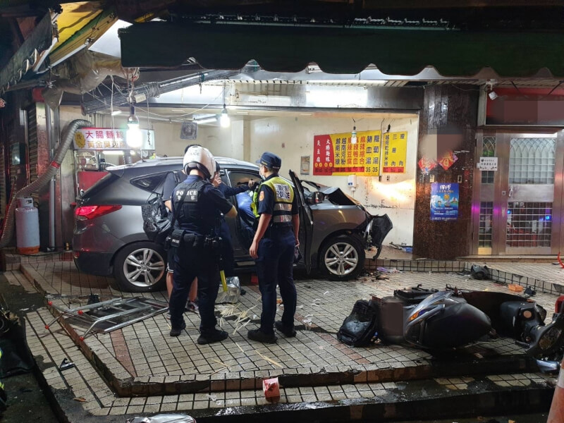 台北市警消17日晚間獲報在內湖區東湖路與安康路交叉口發生一起嚴重車禍，人員到場發現有1輛灰色休旅車衝上騎樓停在小吃店前，車頭損壞、店內物品散落，現場5人分別受到輕重傷。（翻攝畫面）中央社記者劉建邦傳真 113年10月17日