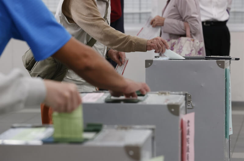 圖為日本民眾27日在東京新宿的投票所投票。（共同社）