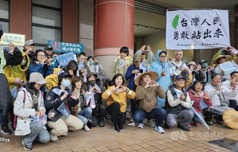 黑熊民防教育協會「台灣主站派、接力護台灣」活動8日進行最後1天行程，雖然鶯歌地區一早下起大雨，但鶯歌車站前仍聚集許多人，現場飄揚「台灣人民勇敢站出來」等標語旗幟，民進黨立委蘇巧慧（前左5）也到場。中央社記者王鴻國攝  113年12月8日