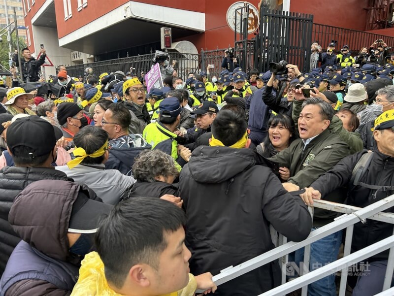 立法院會20日預定審議選罷法等修正草案,立法院外有經濟民主連合等公民團體發起「冬季青鳥在台北」活動,部分群眾企圖翻進立法院,民進黨立委王定宇(右2)等人在旁引導。中央社記者王騰毅攝 113年12月20日