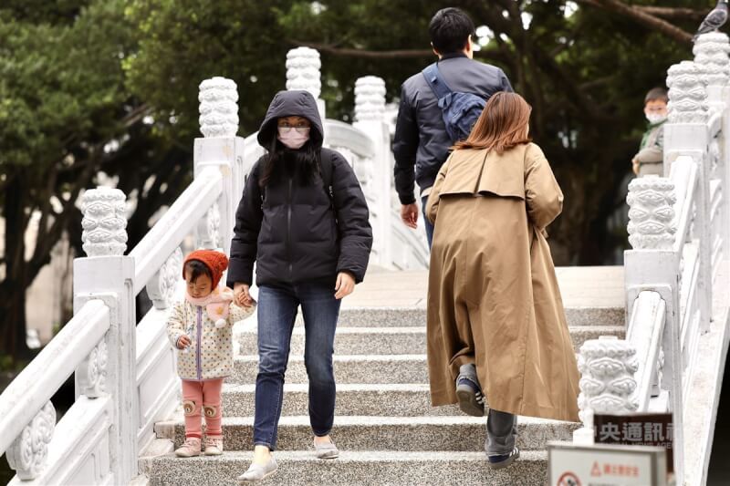 圖為台北市中正紀念公園，民眾穿外套、戴帽子禦寒。（中央社檔案照片）