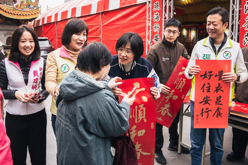 民進黨新北市黨部主委蘇巧慧（後右3）11日與同黨立委張宏陸（後右）、議員戴瑋姍（後左）及石一佑（後左2）等人在板橋接雲寺發放春聯，吸引不少民眾領取。（民進黨新北市黨部提供）中央社記者黃旭昇新北市傳真  114年1月11日