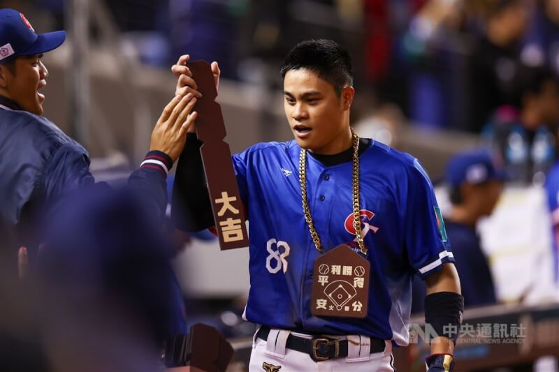 宋晟睿(右)22日對戰南非成功回到本壘得分,開心收下「大吉」。中央社記者王騰毅攝 114年2月22日