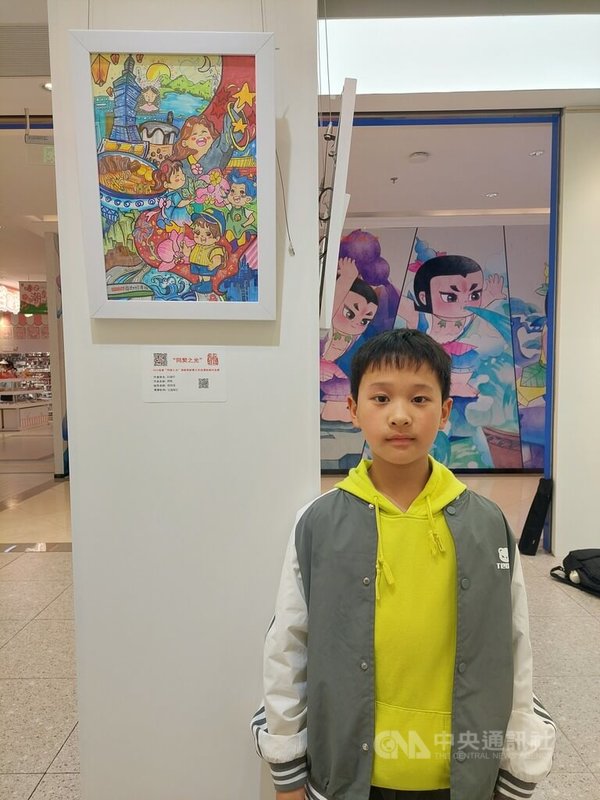 首屆「同契之光」海峽兩岸青少年動漫繪畫作品展中,在上海就讀小學三年級的阮彧杰5日站在自己作品前。因以兩岸為主題,他將台北101和原住民姑娘等台灣元素放入畫中,相關元素是由畫社老師提供給他們參考的。中央社記者張淑伶上海攝 114年4月6日