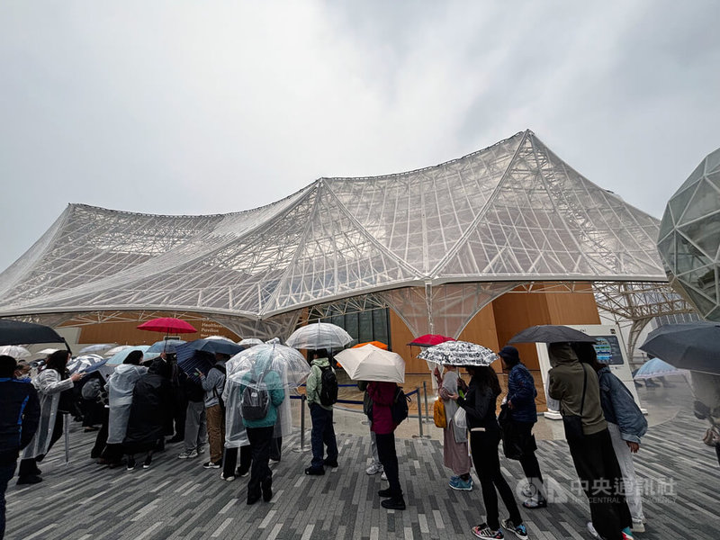 大阪世博開幕3天下來發現了不少問題,正在陸續補強中。圖為13日開幕日下午下起大雨,民眾撐傘排隊,事後感想都是又溼又冷。中央社記者戴雅真大阪攝 114年4月15日