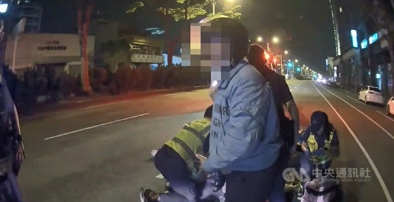 台中李姓男子21日凌晨身體不適,由李母(前)騎機車載送要到醫院掛急診,行經大里區德芳南路近大里路口時,李男突然摔落機車無呼吸心跳,李母報案後,消防人員與警方到場處理。(翻攝照片)中央社記者蘇木春傳真 114年4月21日