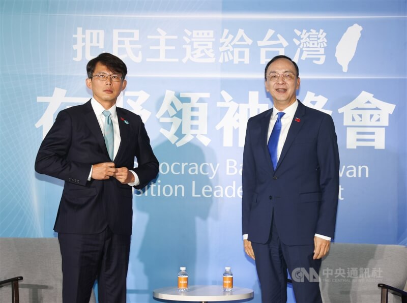 國民黨主席朱立倫（右）、民眾黨主席黃國昌（左）22日在台北出席「把民主還給台灣：在野領袖峰會」，黃國昌西裝上別著KP與國旗徽章，朱立倫則在西裝上別著國旗徽章，兩人準備合影。中央社記者謝佳璋攝 114年4月22日