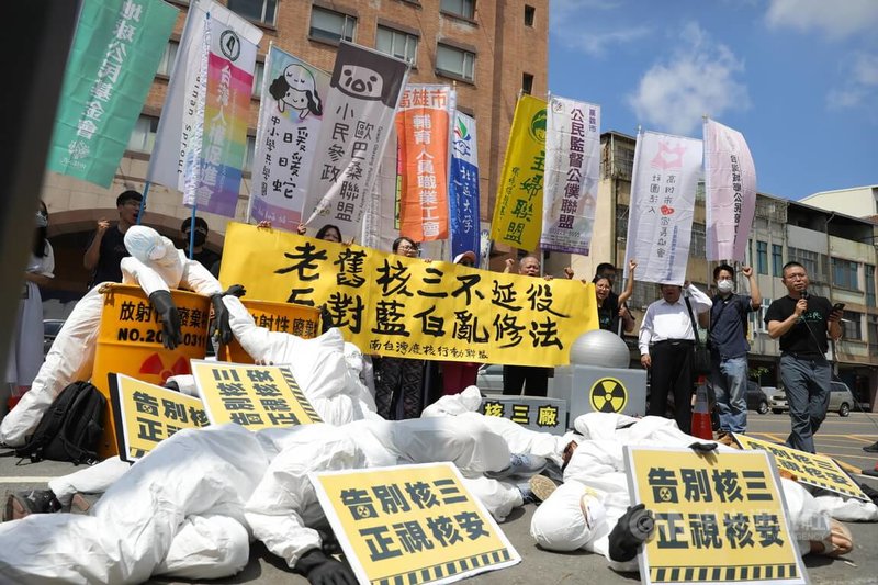 南台灣廢核行動聯盟等20個公民團體及第三勢力政黨23日到國民黨高雄市黨部前,手舉布條、高喊「老舊核三不延役,反對藍白亂修法」口號,並上演模擬核三廠發生核子事故行動劇,呼籲正視核災風險。中央社記者張已亷攝 114年4月23日