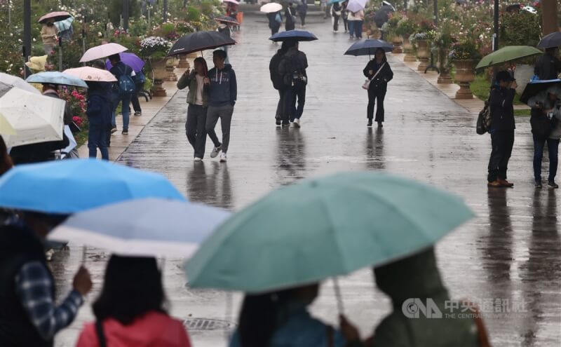 圖為雨天台北市新生公園內民眾。(中央社檔案照片)
