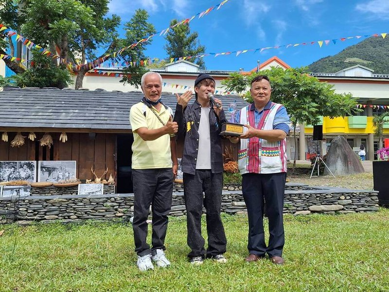 台東縣延平鄉武陵國小28日舉行百年校慶活動,學校傳承布農文化興建的傳統家屋落成揭幕,歌手王宏恩(中)特別返鄉與師生一同為母校慶生。(武陵國小提供)中央社記者盧太城台東傳真 114年6月28日