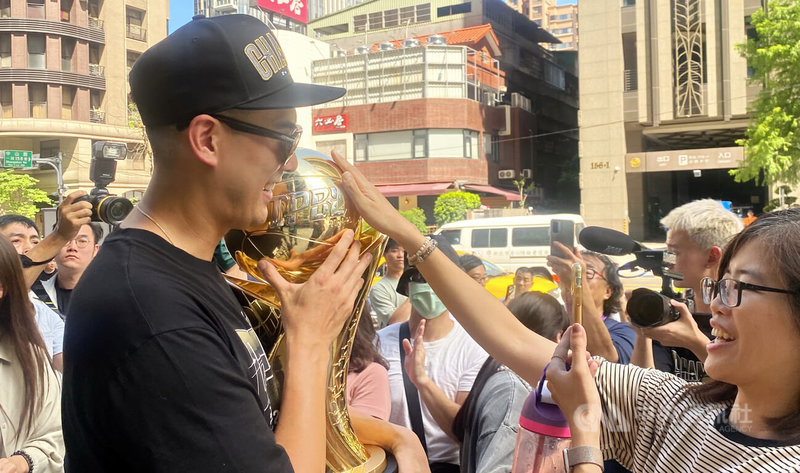 台灣職業籃球大聯盟(TPBL)新北國王1日下午舉辦封王遊行,球員搭乘雙層巴士從主場新莊體育館出發,抵達新北市府前廣場時,市府員工上前觸摸冠軍獎盃,共享喜悅。中央社記者黃旭昇新北市攝 114年7月1日