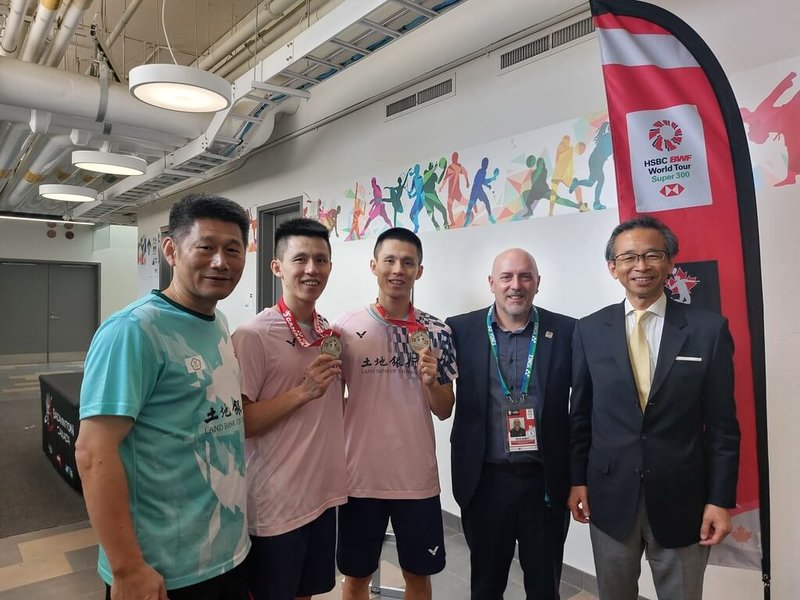 李芳任、李芳至雙胞胎兄弟檔在加拿大羽球公開賽男雙摘金。駐多倫多辦事處長梁毅鵬（右1）與賽事主辦方加拿大羽球協會會長梅瑞特（右2）在賽後向他們及其教練李松遠（左1）致賀。（駐多倫多辦事處提供）中央社記者胡玉立多倫多傳真󠄉  114年7月8日