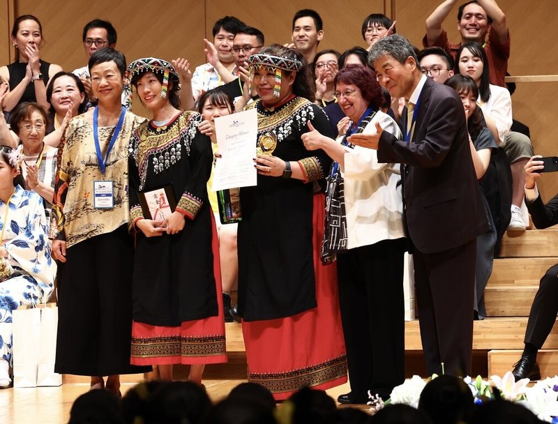 台灣合唱團赴日本參加東京國際合唱大賽,臨時遭到中國抗議要求撤下國旗。儘管賽前心情受到影響,但來自高雄的尼布恩合唱團27日如常發揮,晚間傳出捷報,以95.9的高分奪得民謠組金牌,由兩名代表接受評審頒獎。(尼布恩合唱團提供)中央社記者戴雅真東京傳真 114年7月27日