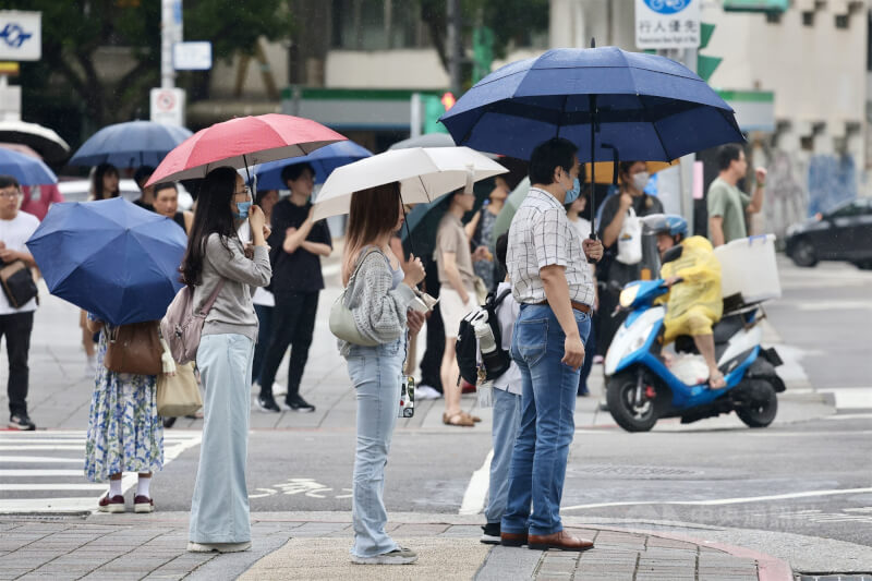 圖為10日午後北市民眾撐傘遮擋間歇雨勢。中央社記者王飛華攝　114年8月10日