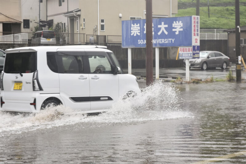 日本熊本市一台車輛11日在淹水地區行駛。（共同社）