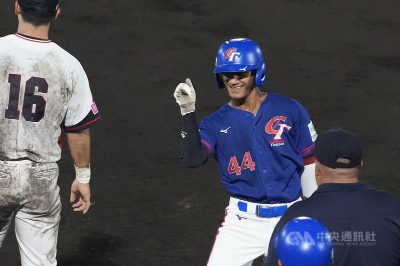 U18世界盃棒球賽在日本沖繩舉行,台灣隊超級循環賽首戰11日與韓國交手,3局上,台灣隊打者帕蘇拉.塔基斯利尼安(右)擊出首支安打,上壘後朝休息區綻出笑容。中央社記者徐肇昌沖繩攝 114年9月11日