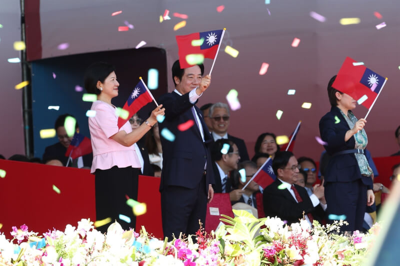 中華民國中樞暨各界慶祝114年國慶大會10日在總統府前廣場舉行,總統賴清德(前左2)與夫人吳玫如(前左)揮舞國旗,向台下群眾致意。中央社記者王騰毅攝 114年10月10日