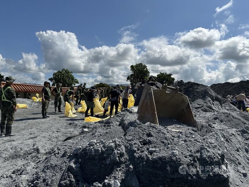 馬太鞍溪堰塞湖溢流重創花蓮光復鄉，花蓮縣政府13日函請行政院等取消「垂直避難」，由中央擬定與執行撤離計畫。圖為志工在重災區大平村協助清除土砂。中央社記者李先鳳攝　114年10月13日
