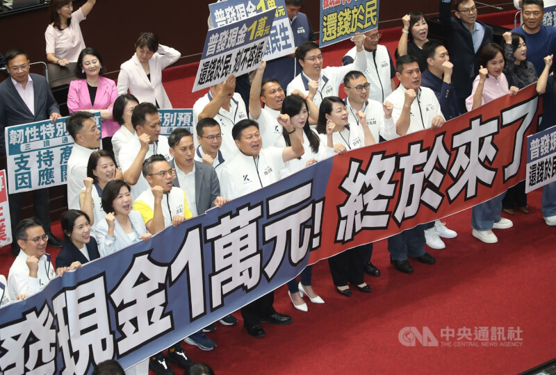 立法院17日三讀通過攸關普發現金的韌性特別預算案,國民黨立法院黨團總召傅崐萁(前左6)等人拿著「普發現金1萬元!終於來了!」的布條振臂呼口號。中央社記者吳家昇攝 114年10月17日