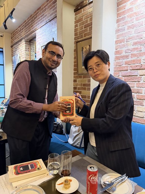 台灣小說家楊双子(右)在印度介紹其著作「台灣漫遊錄」,親自為參加活動的來賓簽書,並與來賓合影,為活動畫下完美句點。中央社記者李晉緯新德里攝 114年11月5日