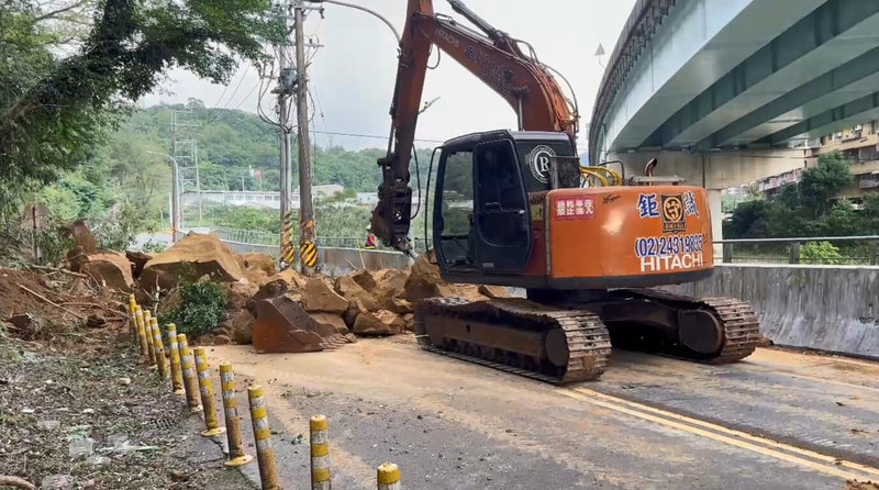 基隆市暖暖區興隆街一處邊坡7日下午崩塌，落石占據路面導致交通中斷，市府獲報迅速調派怪手、鏟裝機、卡車及工程人員到場搶修。（讀者提供）中央社記者王朝鈺傳真　114年11月7日