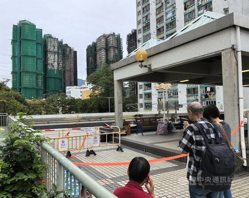 香港大埔宏福苑發生大火慘劇一週之後，唯一未受波及的大樓住戶3日獲得當局批准回家取回物品；圖左有圍網大樓就是未受大火波及的宏志閣。中央社記者張謙香港攝　114年12月3日
