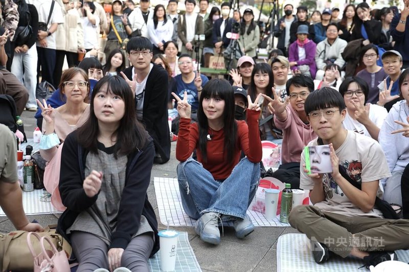 「與白安路邊野餐」活動7日下午在台北東區舉行,歌手白安(前紅衣)與歌迷一同合影留念。中央社記者翁睿坤攝 114年12月7日