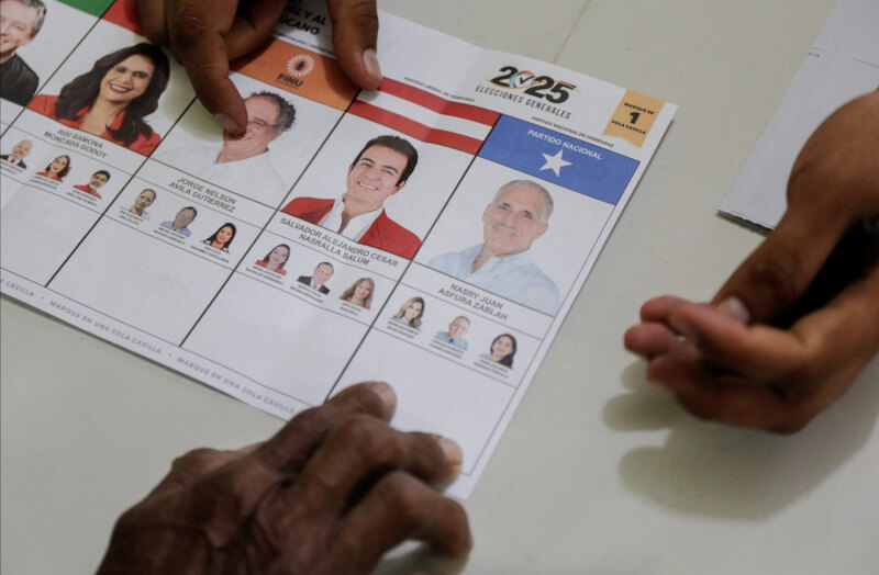 宏都拉斯總統選舉工作人員向選民展示選舉文件。選舉結果仍在計票中。（路透社）