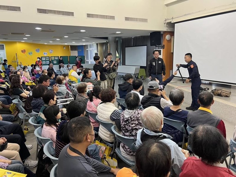 台北隨機傷人事件引發全台關注，民進黨高雄市議員林智鴻（後立者右2）20日在講座活動中攜手警方宣導自保術，輔以背包、雨傘、外套等日常物品示範動作，與會民眾專注聆聽。（林智鴻服務處提供）中央社記者林巧璉傳真　114年12月20日