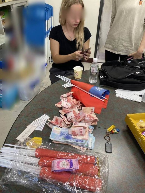 台中近日出現一外籍金髮女子自稱聾啞人士，以「籌措旅費」為由兜售國旗。移民署中區事務大隊台中市專勤隊23日在大里區查獲此名持停留簽證的俄羅斯籍女子，依法將驅逐出國。（民眾提供）中央社記者趙麗妍傳真　114年12月23日