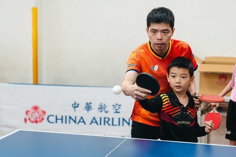 中華航空舉辦公益桌球營，今年移師彰化，並第3度邀請台灣桌球教父莊智淵（後）示範桌球技巧，與學童進行互動教學，包含暖身、握拍、接發球、移動步伐與反應訓練等。（華航提供）中央社記者余曉涵傳真　114年1月5日