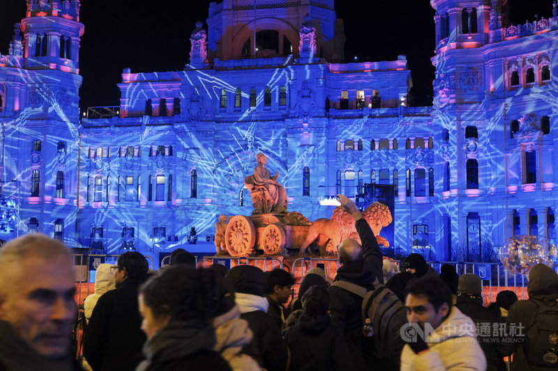 西班牙首都馬德里5日晚間舉行年度「三王節遊行」（Cabalgata de los Reyes），活動以市政廳施放的燦爛煙火秀畫下句點後，許多民眾與遊客仍依依不捨地逗留，與點綴了繽紛燈光的西貝萊斯噴泉及馬德里市政廳合影後，才心滿意足離場。中央社記者胡家綺馬德里攝 115年1月6日