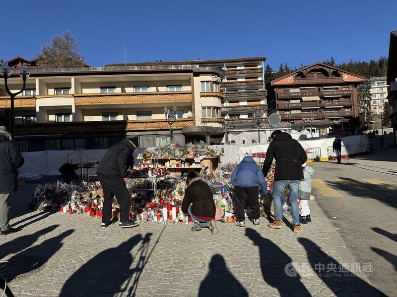 瑞士克蘭蒙丹納一間酒吧發生大火後，前來致哀的民眾與採訪媒體，僅能在外圍停留。現場滿是悼念的鮮花與蠟燭。中央社記者郭芳君克蘭蒙丹納攝　115年1月7日