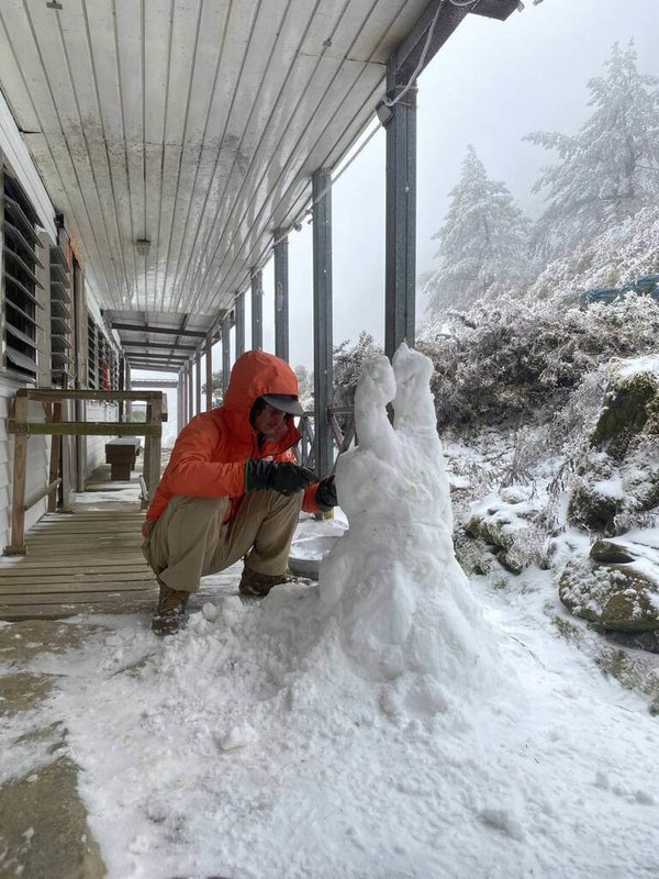 台東山區持續飄雪和冰霰，9日嘉明湖步道從向陽山屋到嘉明湖成銀白世界，山友在山屋堆雪人。（林保署台東分署提供）中央社記者盧太城台東傳真　115年1月9日