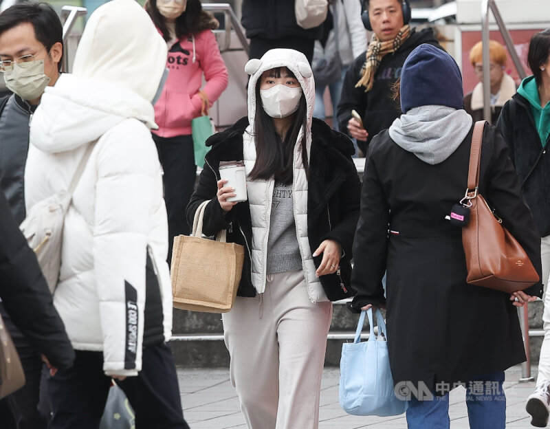 圖為台北市中正區街頭民眾穿外套、戴帽子加強保暖。（中央社檔案照片）